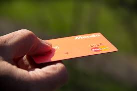 Un hombre sostiene una tarjeta de crédito en el mano
